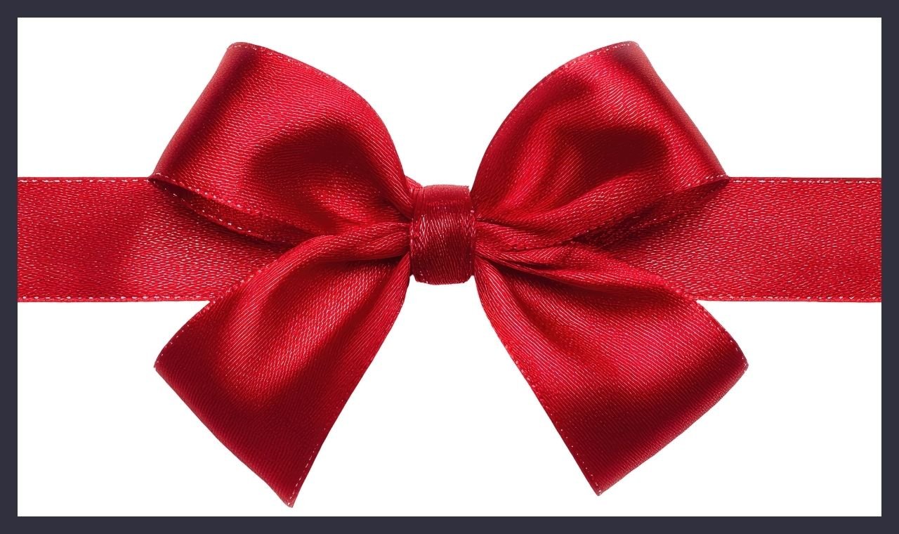 A red satin ribbon tied in a bow on a white card with a dark border